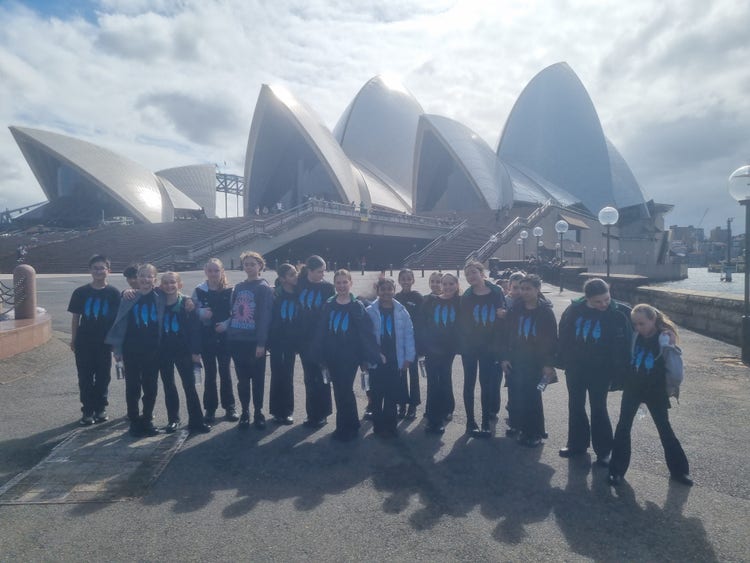 Choral choir standing outside the Sydney Opera House before their performance at the Festival of Choral Music.